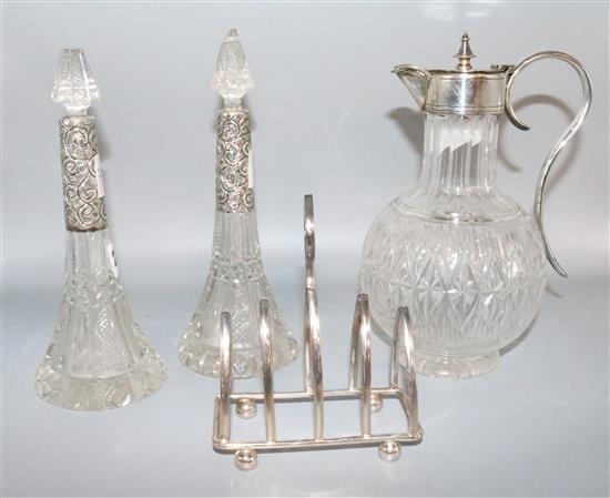 Plated mounted claret jug, toast rack, 2 silver mounted scent bottles and stoppers